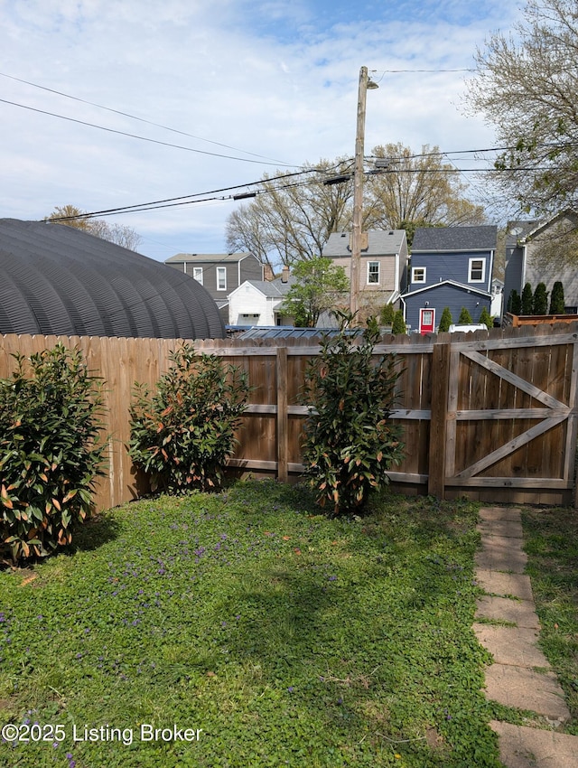 view of yard featuring fence and a gate
