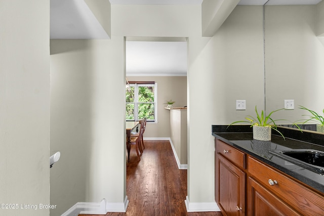 644 S 2nd St Unit 2, Louisville, KY 40202 - bar featuring dark wood-type flooring, baseboards, a sink, and crown molding