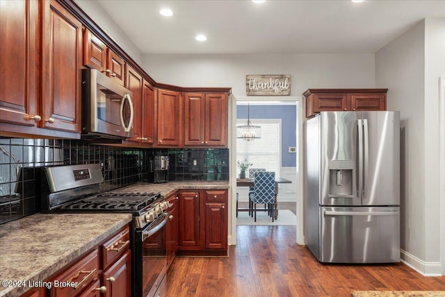 kitchen with backsplash, recessed lighting, dark wood-style floors, and stainless steel appliances