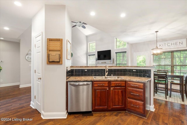 kitchen featuring a peninsula, dark wood finished floors, stainless steel dishwasher, a sink, and ceiling fan
