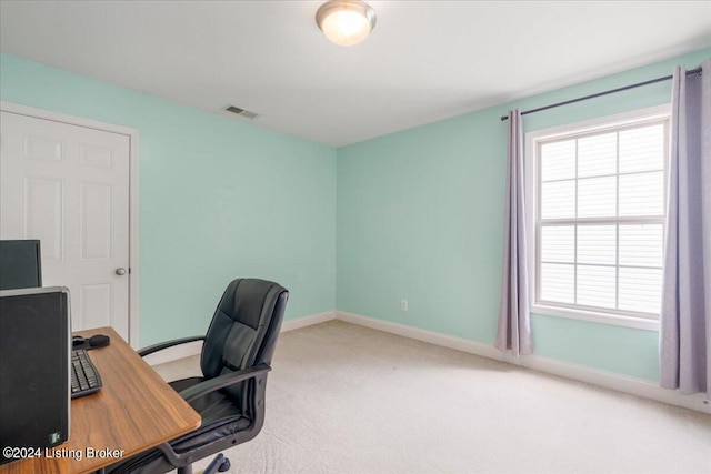 office space featuring visible vents, carpet flooring, baseboards, and plenty of natural light