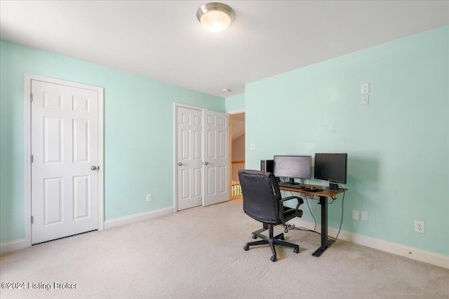 carpeted home office with baseboards