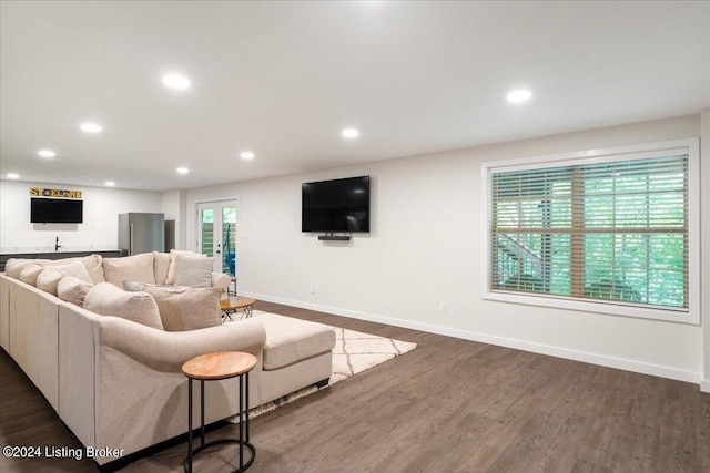 living area featuring baseboards, dark wood-style floors, and recessed lighting