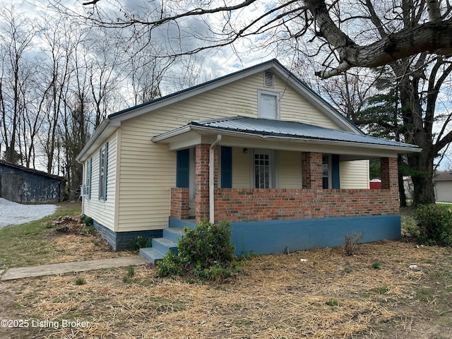 3067 Greensburg Rd, Buffalo, KY 42716 - bungalow featuring a porch, brick siding, and metal roof