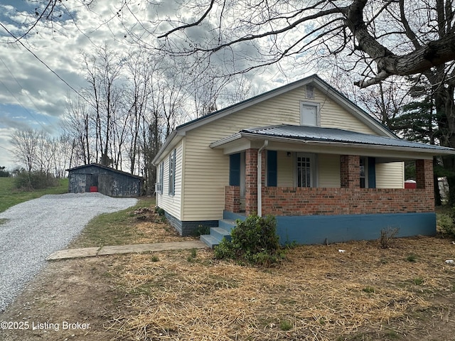 3067 Greensburg Rd, Buffalo, KY 42716 - bungalow featuring an outbuilding, brick siding, and covered porch