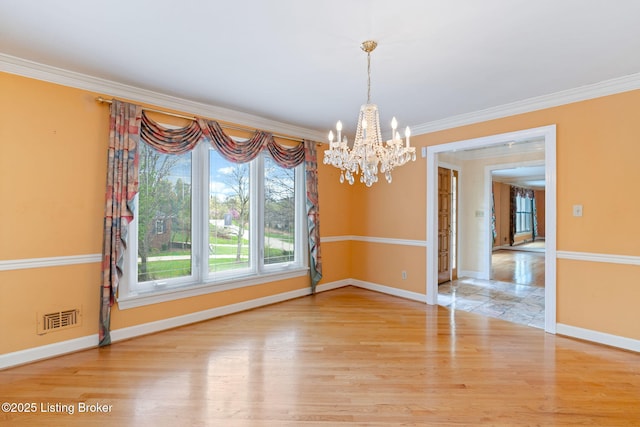 unfurnished dining area featuring a chandelier, light wood finished floors, visible vents, and crown molding