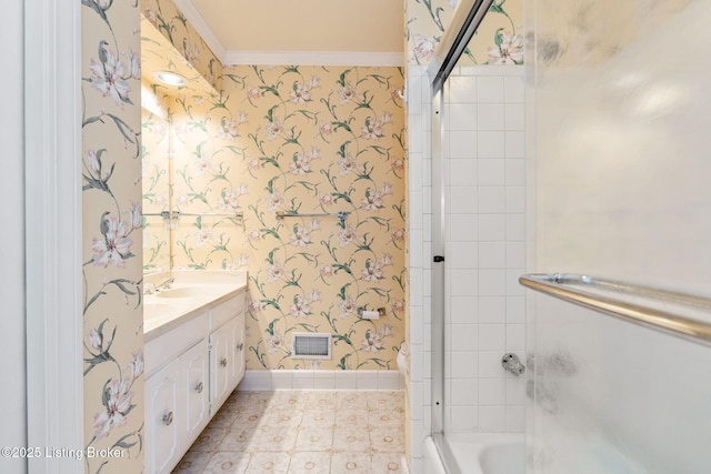bathroom featuring vanity, baseboards, wallpapered walls, shower / washtub combination, and visible vents