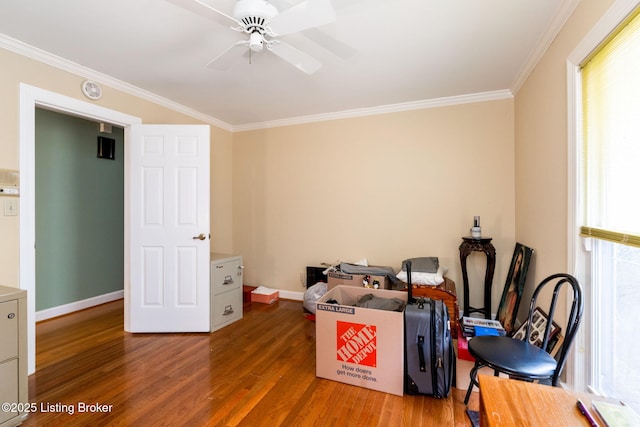 interior space with ornamental molding, baseboards, a ceiling fan, and wood finished floors
