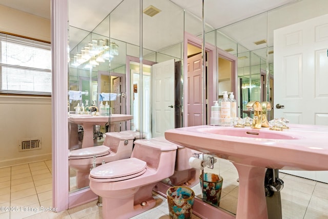 bathroom with toilet, tile patterned floors, and visible vents