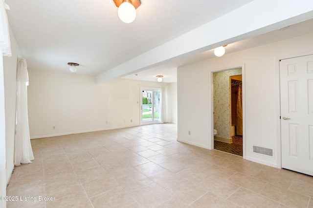 unfurnished room featuring light tile patterned floors, baseboards, and visible vents