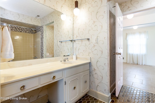 bathroom with tile patterned floors, wallpapered walls, vanity, and walk in shower
