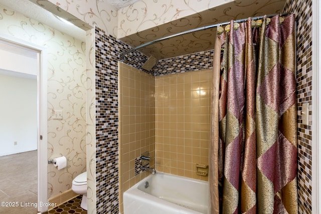 bathroom featuring tile patterned floors, shower / bathtub combination with curtain, wallpapered walls, and toilet