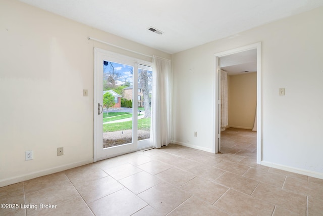 unfurnished room with light tile patterned floors, baseboards, and visible vents