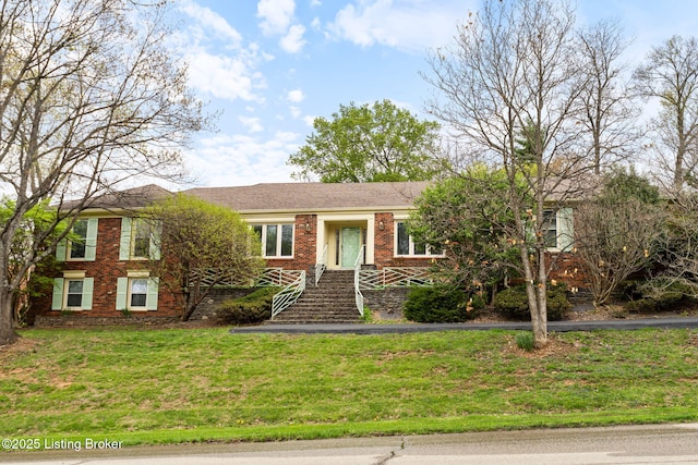 ranch-style house featuring a front yard and brick siding