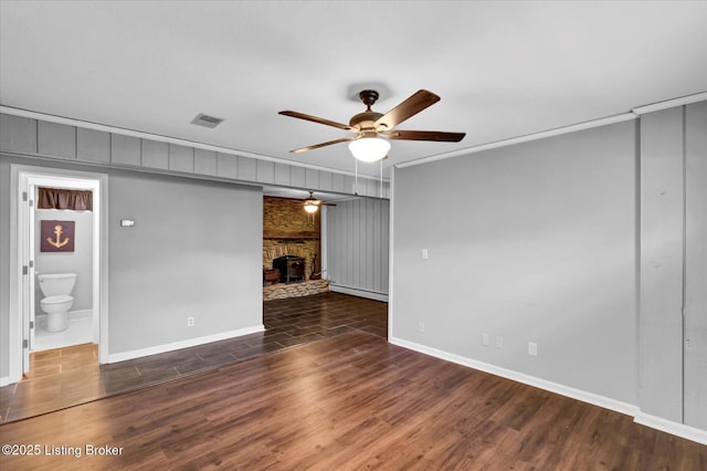 unfurnished living room featuring ornamental molding, visible vents, ceiling fan, and wood finished floors