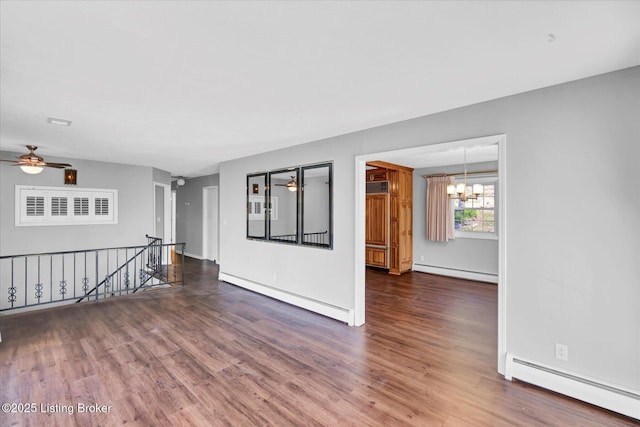 spare room with wood finished floors and baseboard heating