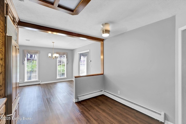spare room featuring a baseboard radiator, a notable chandelier, and dark wood-style floors