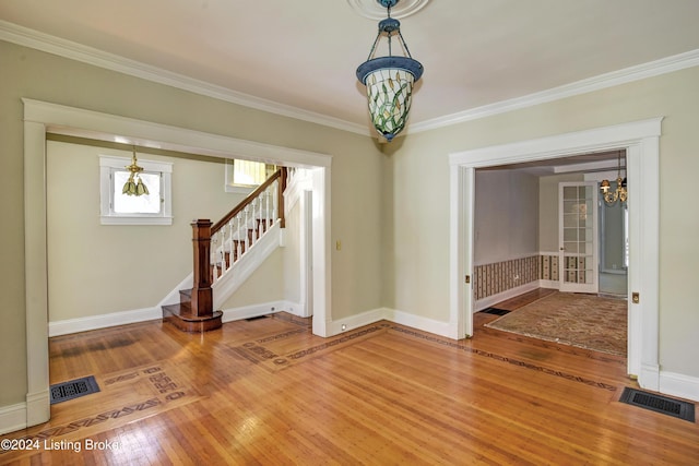 unfurnished room with a chandelier, stairway, visible vents, and light wood finished floors