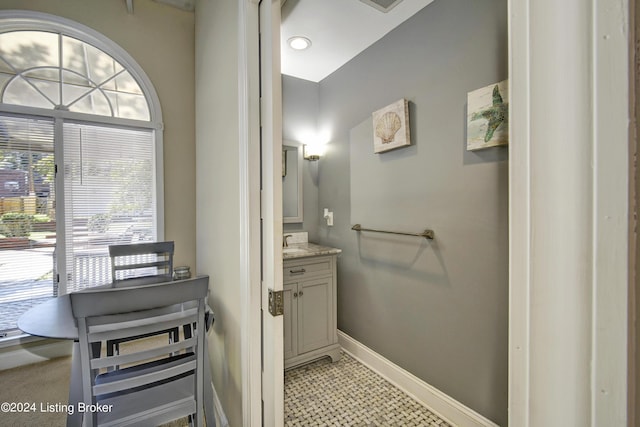 bathroom featuring tile patterned floors, vanity, baseboards, and visible vents