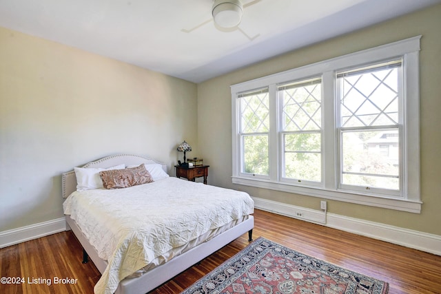 bedroom featuring baseboards, a ceiling fan, and wood finished floors