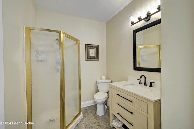 bathroom with toilet, a shower stall, vanity, and baseboards