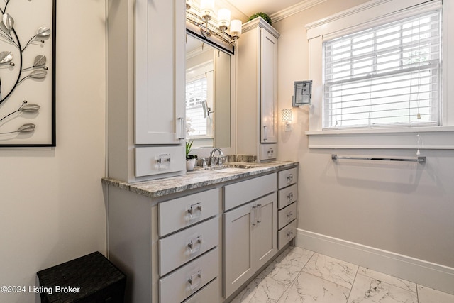 bathroom featuring crown molding, marble finish floor, baseboards, and vanity