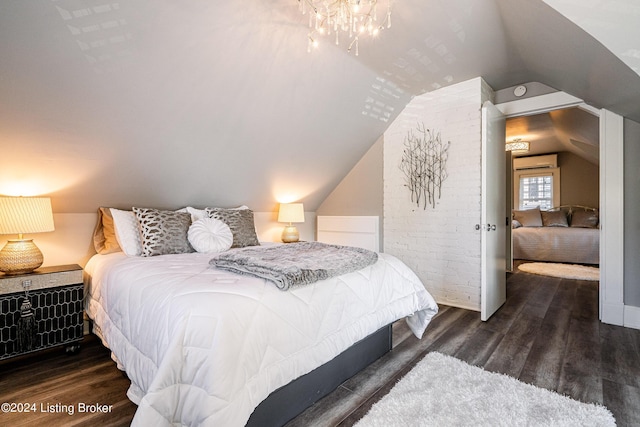 bedroom with a chandelier, lofted ceiling, wood finished floors, and a wall mounted air conditioner