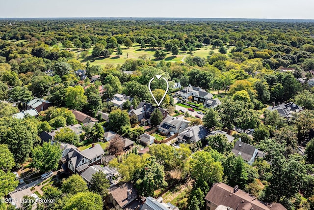 drone / aerial view with a view of trees and a residential view
