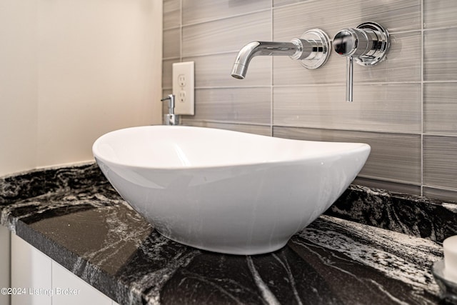full bathroom featuring a sink, tile walls, and a soaking tub