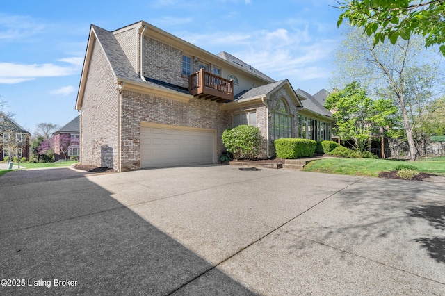 14801 Forest Oaks Dr, Louisville, KY 40245 - view of property exterior featuring brick siding, concrete driveway, a garage, and a balcony