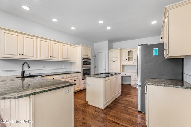 14801 Forest Oaks Dr, Louisville, KY 40245 - kitchen with a peninsula, dark wood-style floors, cream cabinets, stainless steel appliances, and a sink