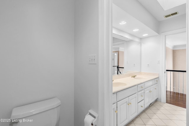 14801 Forest Oaks Dr, Louisville, KY 40245 - bathroom featuring visible vents, toilet, a skylight, a sink, and double vanity