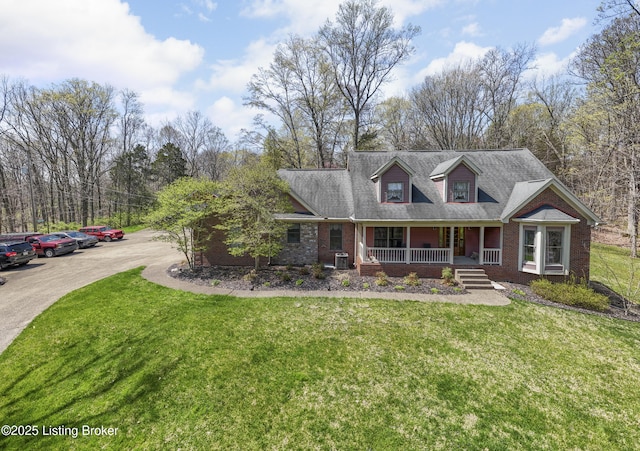 3502 Wilderness Trl, Louisville, KY 40299 - new england style home with covered porch, a front yard, central AC unit, and brick siding
