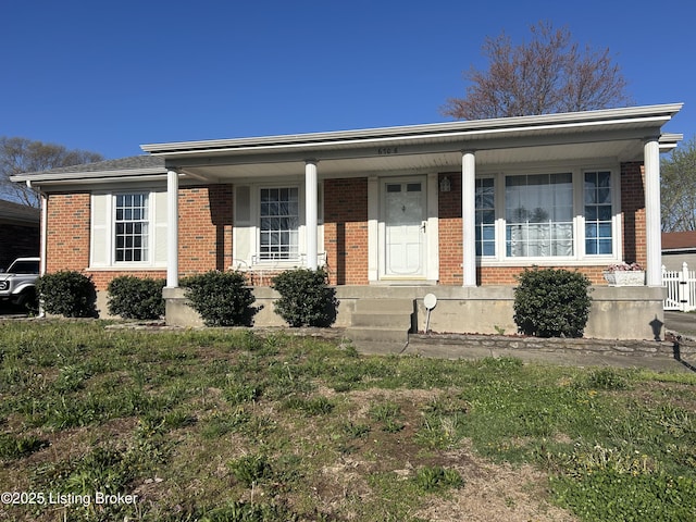 view of front of home featuring covered porch and brick siding