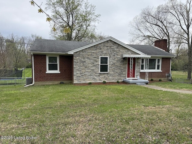 ranch-style house with central AC, a trampoline, a front yard, and a chimney