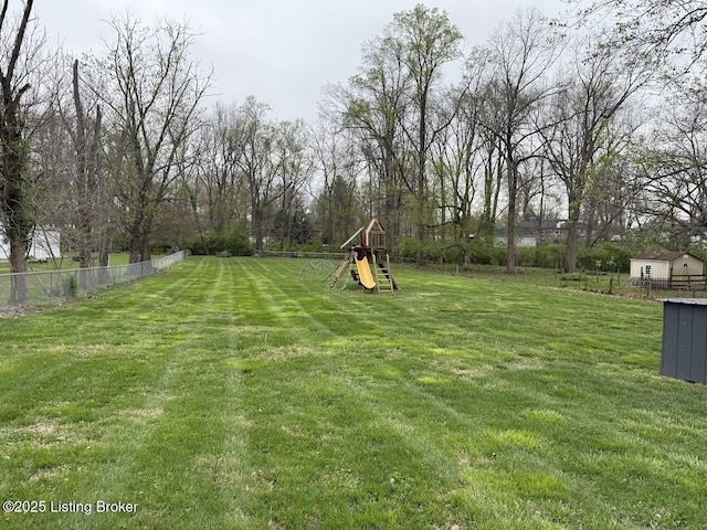 view of yard featuring fence and a playground