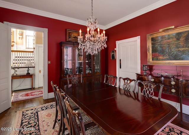 dining space with a chandelier, baseboards, ornamental molding, and wood finished floors
