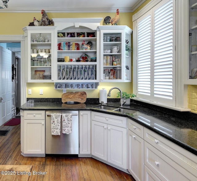 kitchen with a healthy amount of sunlight, dishwasher, a sink, and white cabinets