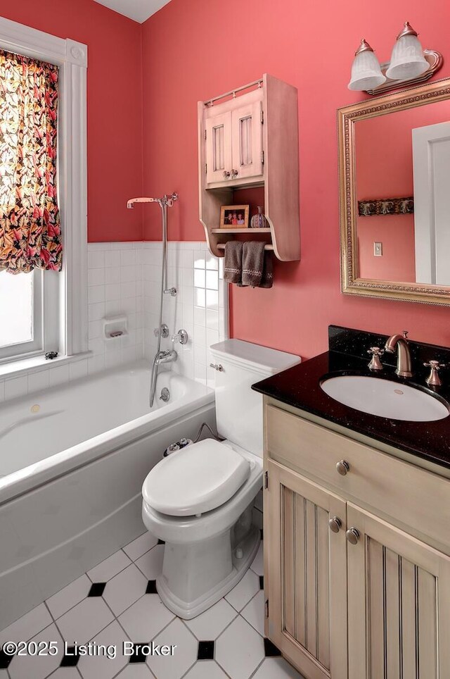 bathroom with a tub to relax in, toilet, vanity, and tile patterned floors