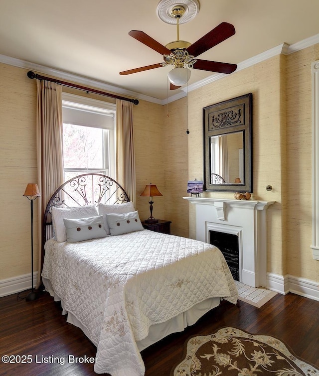 bedroom featuring crown molding, wood finished floors, and baseboards