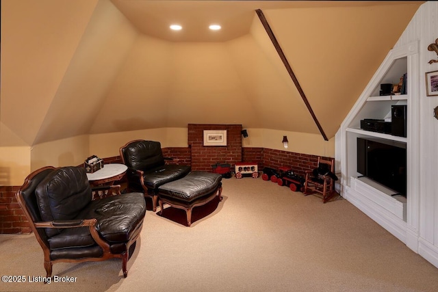 sitting room with carpet flooring, vaulted ceiling, and built in features