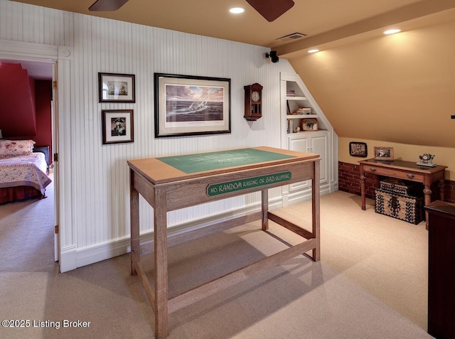 rec room featuring built in features, vaulted ceiling, carpet floors, visible vents, and ceiling fan