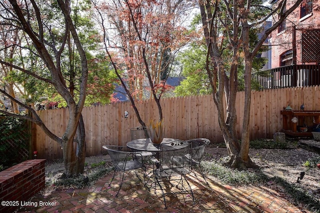 view of patio with a fenced backyard and outdoor dining area