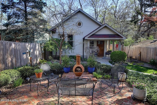 rear view of property with a patio area and a fenced backyard