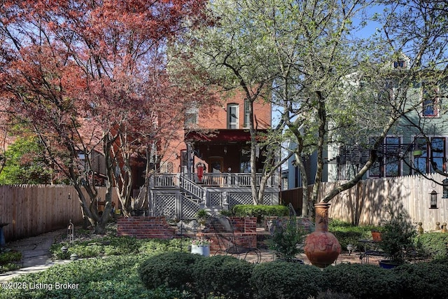 view of yard with a fenced backyard and stairway