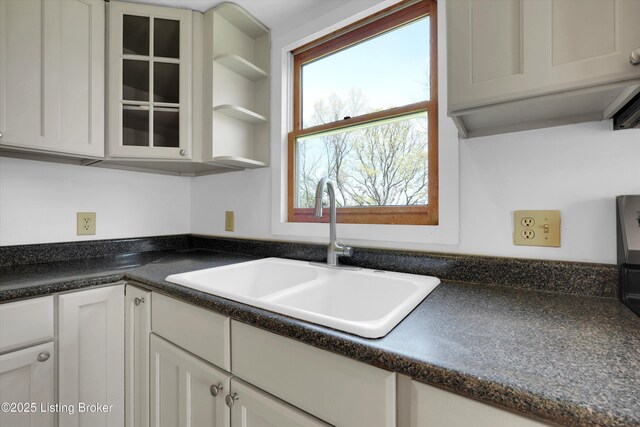 7700 Organ Creek Rd, Pendleton, KY 40055 - kitchen with glass insert cabinets, dark countertops, a sink, and white cabinets