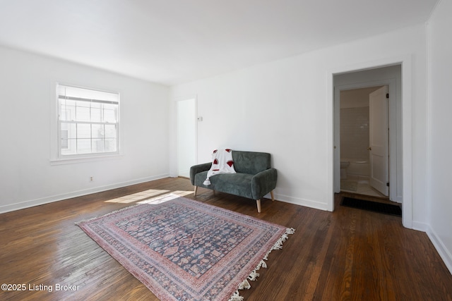 living area with baseboards and wood finished floors