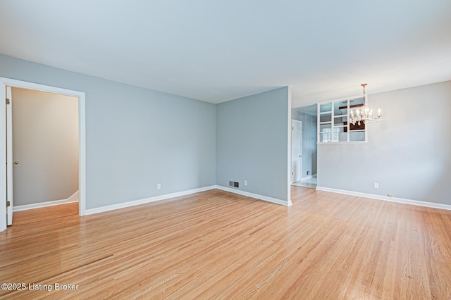 3014 Nadina Dr, Louisville, KY 40220 - unfurnished living room featuring a chandelier, visible vents, light wood-type flooring, and baseboards