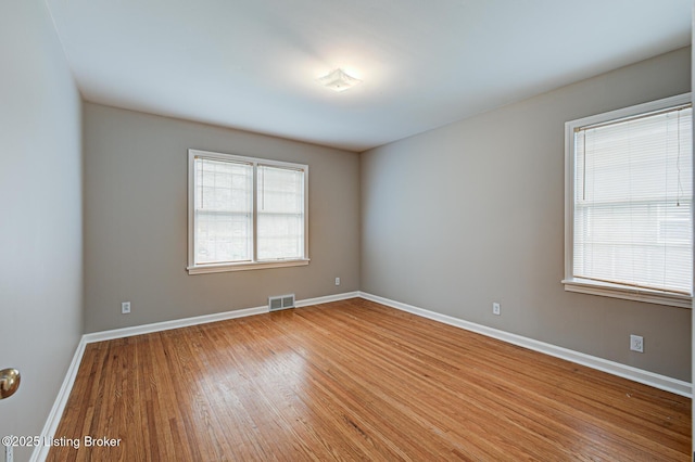 3014 Nadina Dr, Louisville, KY 40220 - empty room with wood finished floors, baseboards, visible vents, and a wealth of natural light