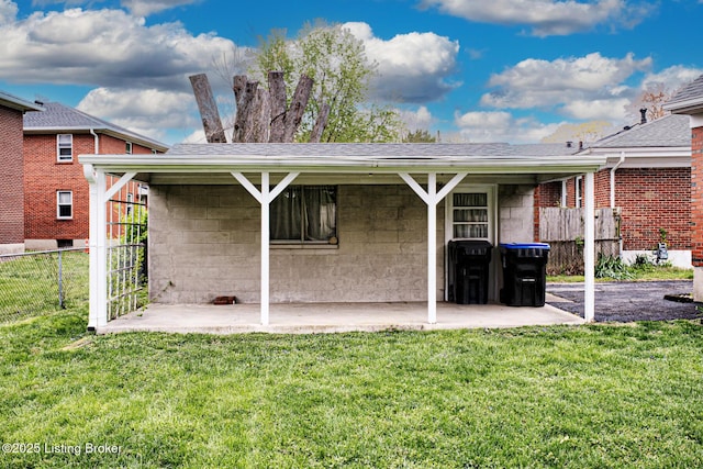 3014 Nadina Dr, Louisville, KY 40220 - back of house with a yard, concrete block siding, fence, and a patio area